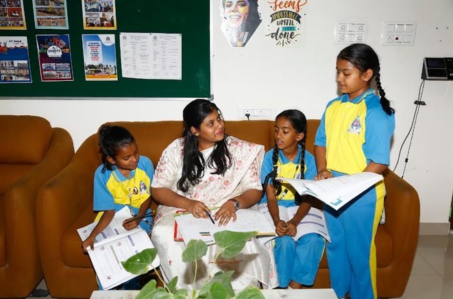 A teacher working through a reading task with a small group of students