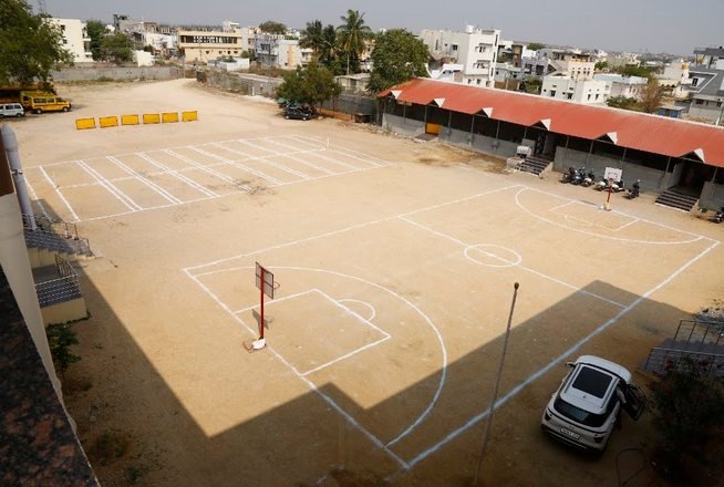 The Royal Concorde campus grounds, with the marked court and school buildings