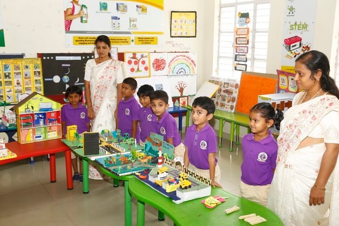 Kindergarten children presenting a model project with their teachers